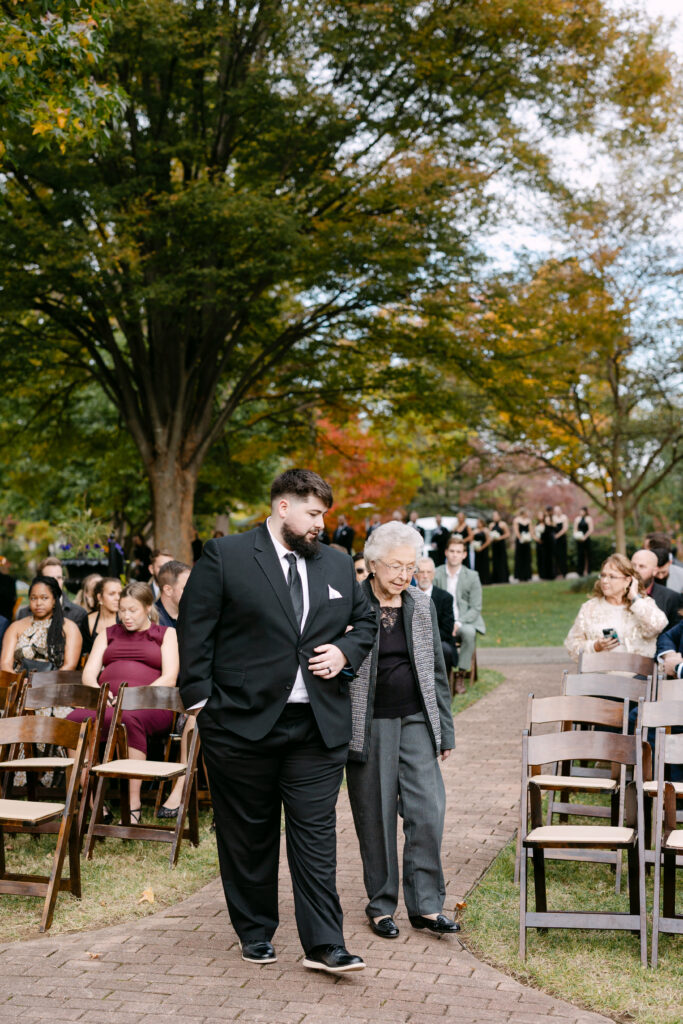 Grandmother escorted down aisle by grandson at Peterson Dumesnil House wedding ceremony
