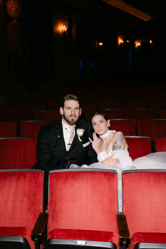 Moody couples portrait inside the Louisville Palace theater during an elegant Phantom of the Opera themed wedding in Louisville