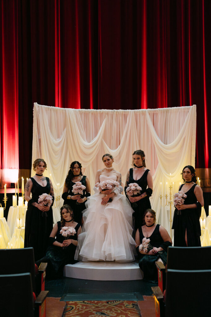 Bridal party portrait in front of custom draping at the Louisville Palace wedding venue in Louisville Kentucky