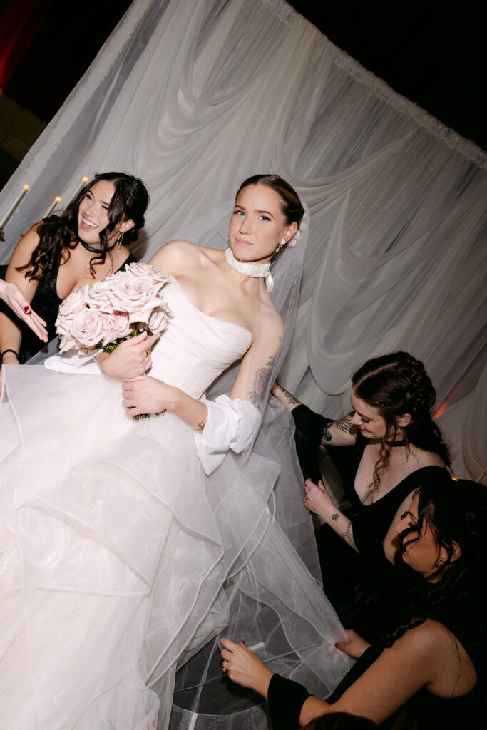 Bridal party portrait in front of custom draping at the Louisville Palace wedding venue in Louisville Kentucky