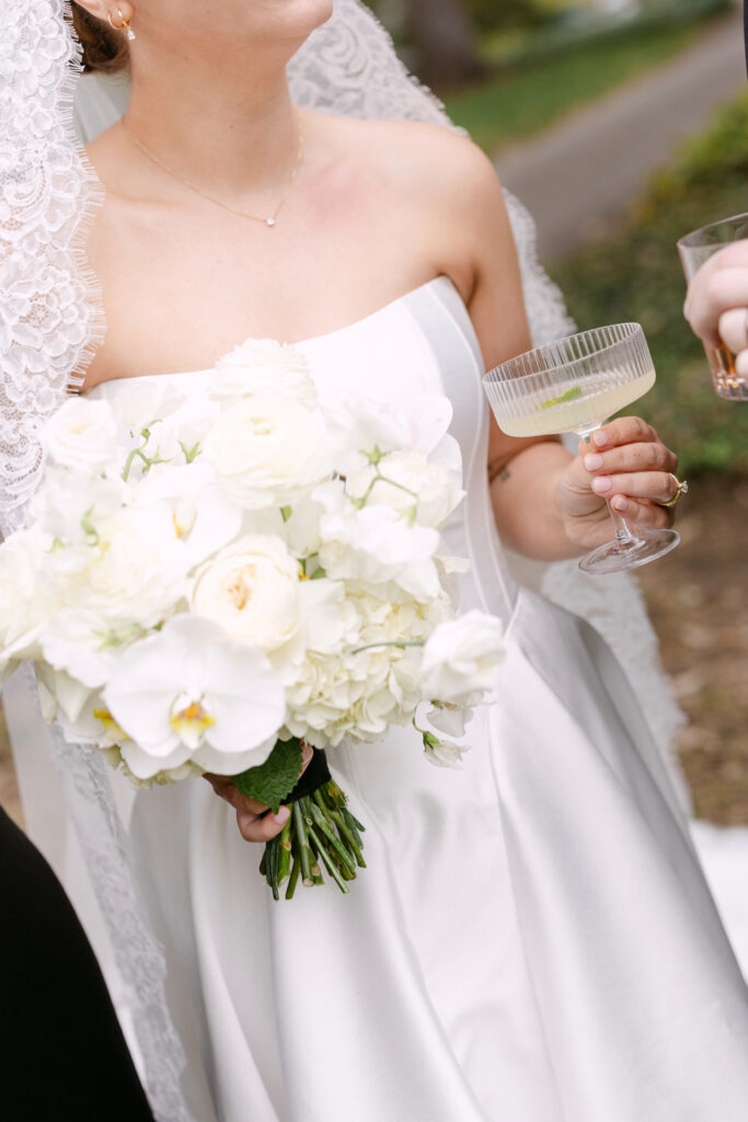 Bride holding coupe glass during reception at Peterson Dumesnil House wedding in Louisville KY