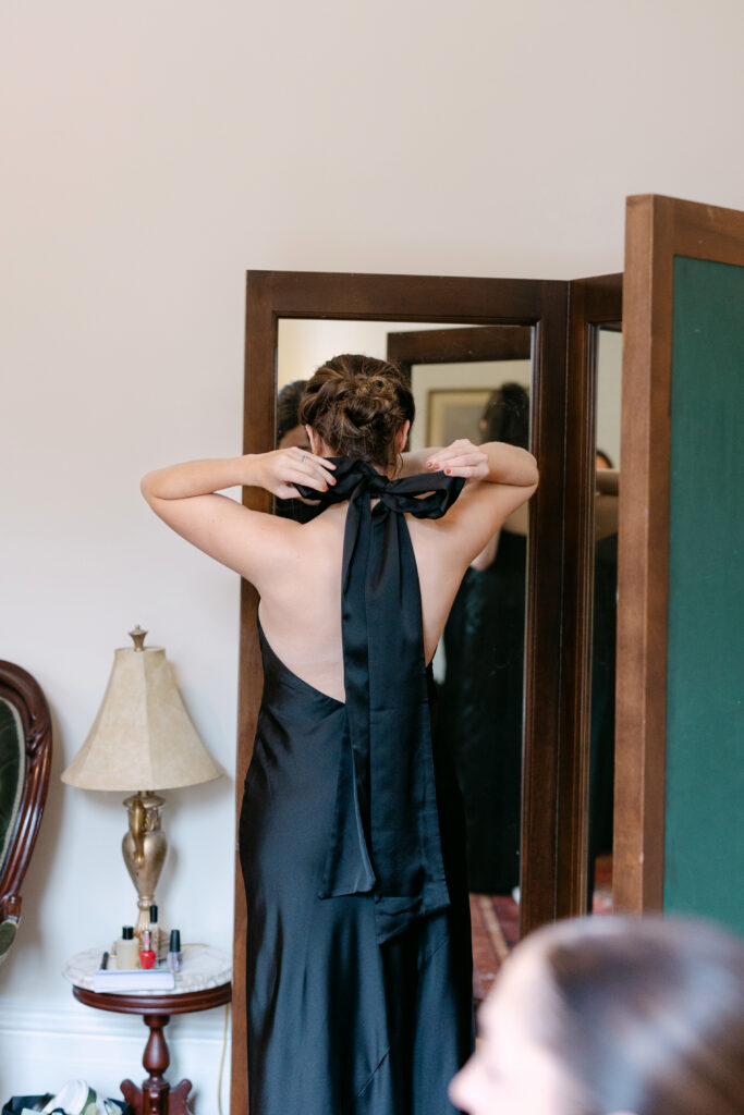 Bridesmaid getting ready inside bridal suite at Peterson Dumesnil House in Louisville Kentucky