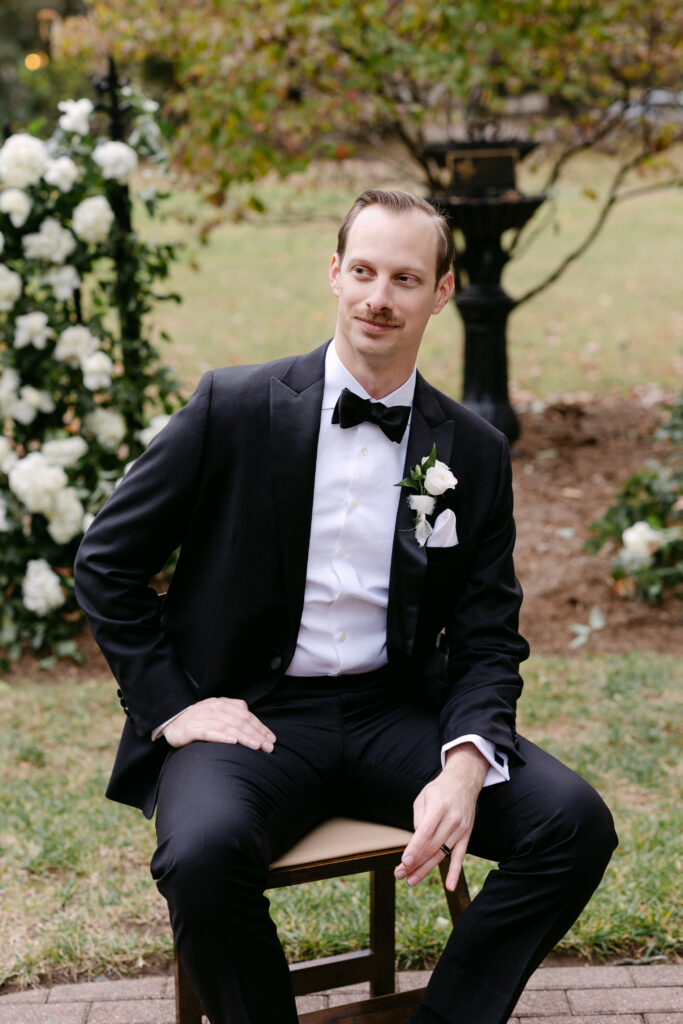 Groom portrait in garden ceremony space at Peterson Dumesnil House in Louisville KY
