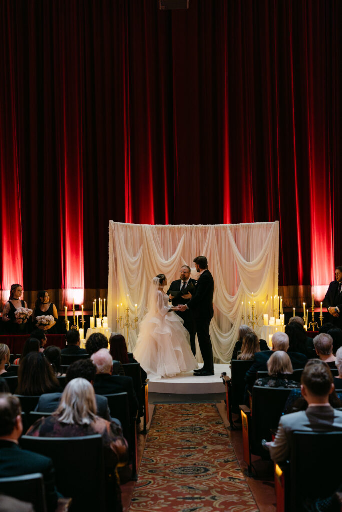 Wedding ceremony inside the Louisville Palace theater with romantic candlelight in downtown Louisville KY