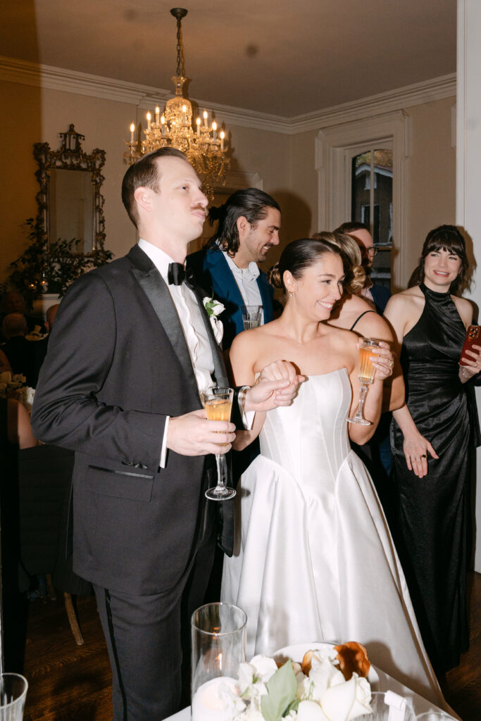Bride and groom listening to heartfelt speeches at Peterson Dumesnil House wedding