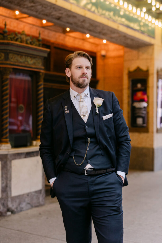 Groom portrait in front of the iconic Louisville Palace marquee in downtown Louisville KY wedding setting