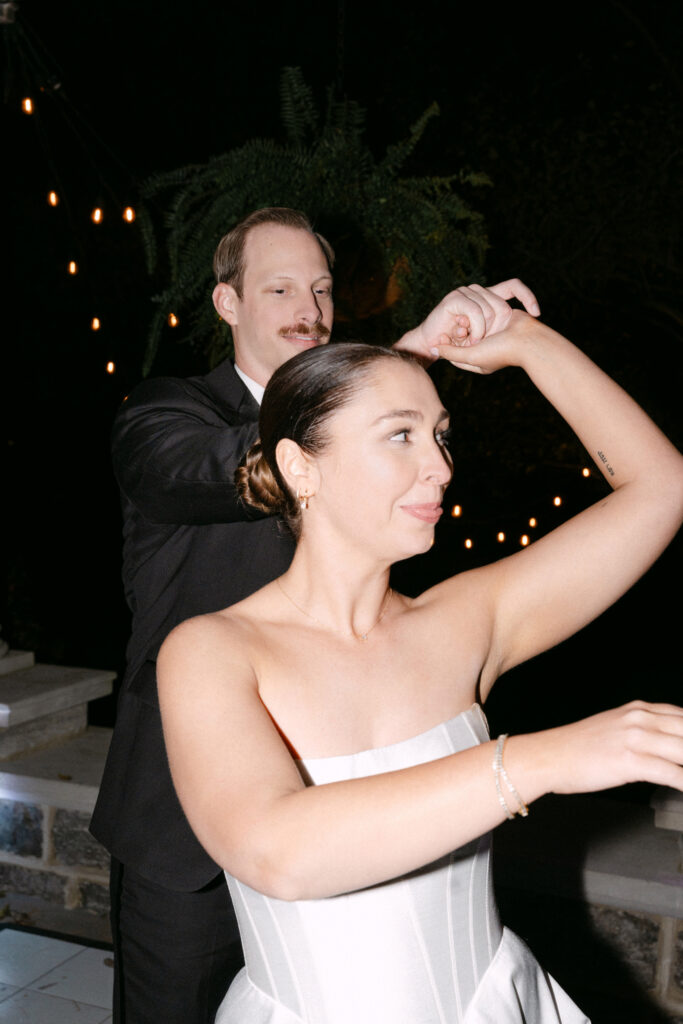 Groom spinning bride on dance floor at Peterson Dumesnil House wedding reception