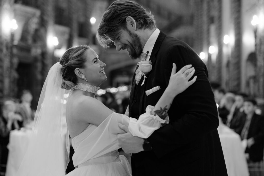 First dance inside the Louisville Palace with dramatic lighting during a romantic Louisville Kentucky wedding