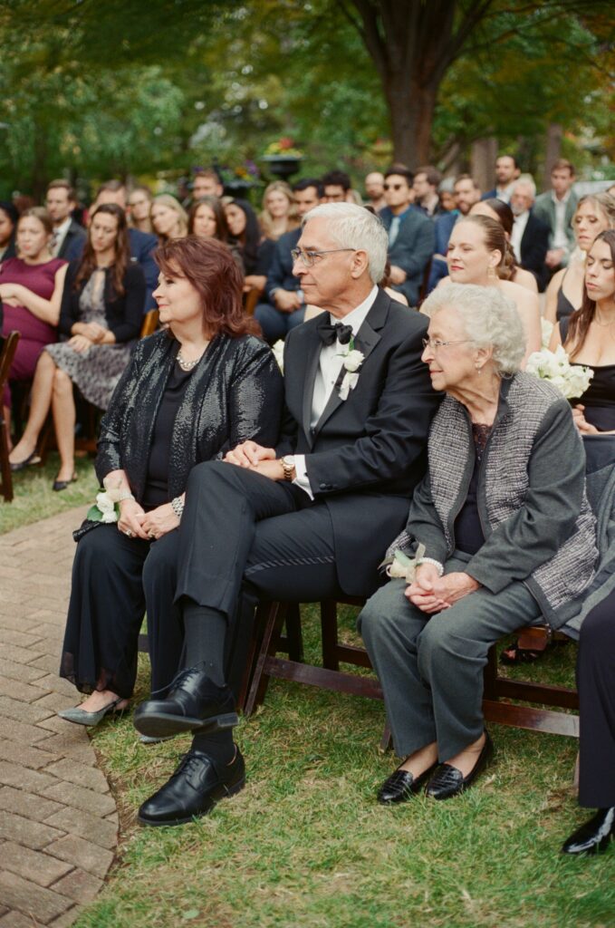 Bride’s family watching emotional garden ceremony at Peterson Dumesnil House wedding in Louisvill