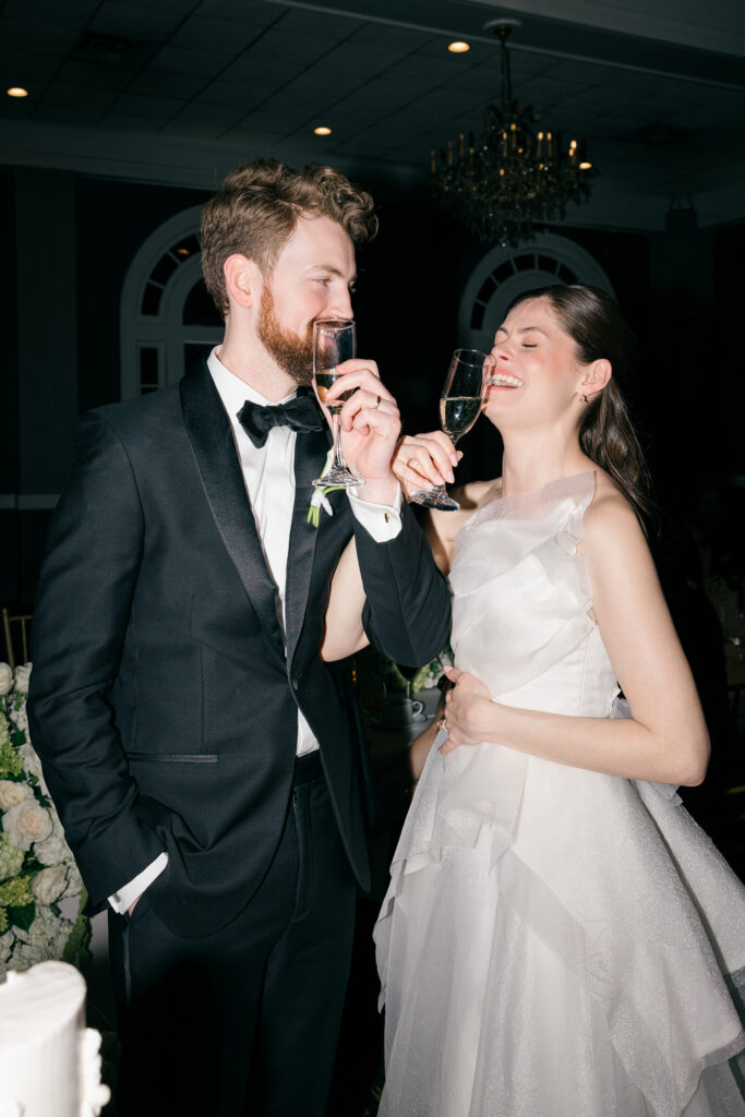 Bride and groom champagne toast during classic black tie wedding at The Olmsted Louisville KY