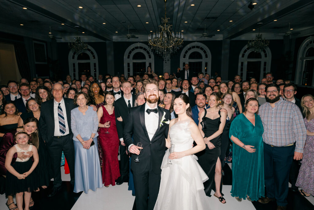Bride and groom celebrating on packed dance floor with guests at The Olmsted Louisville wedding reception