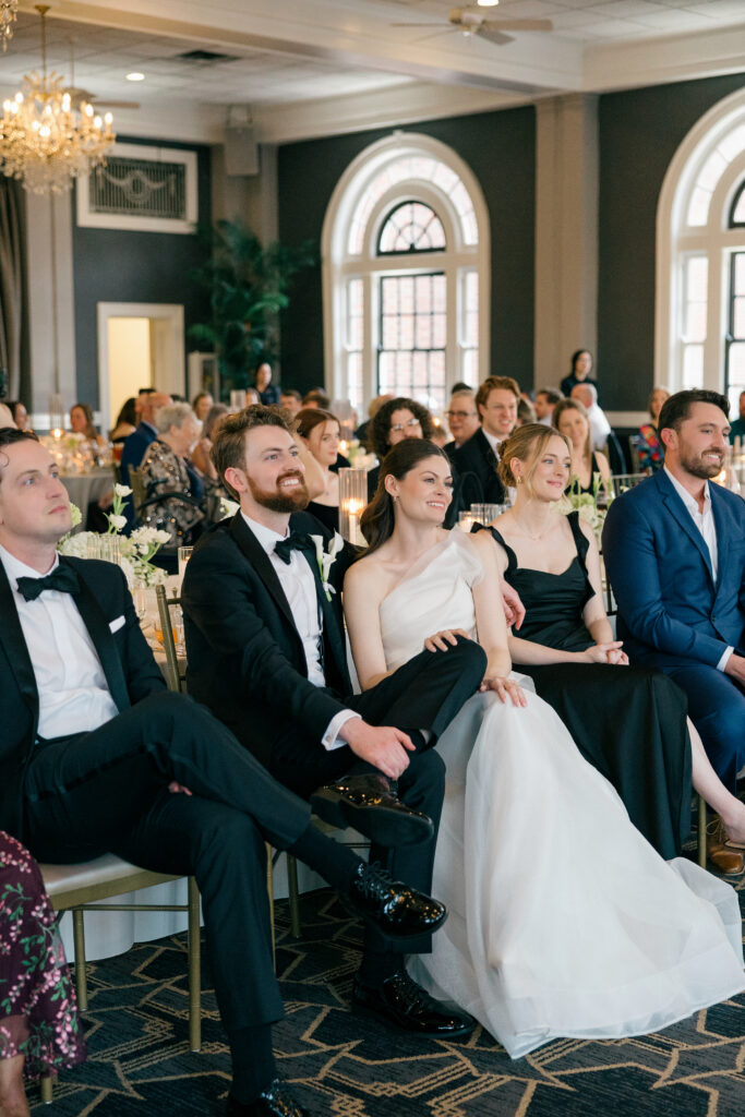 Newlyweds listening to heartfelt wedding toasts during reception at The Olmsted Louisville