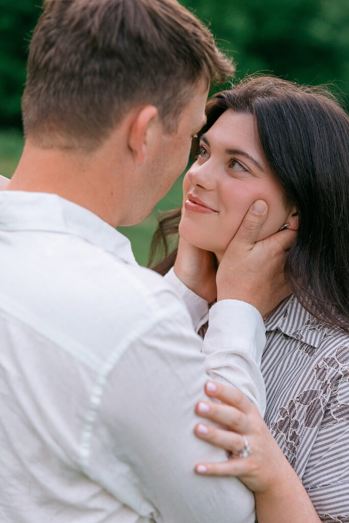 Engaged couple smiling together in a secluded area of Cherokee Park Louisville KY