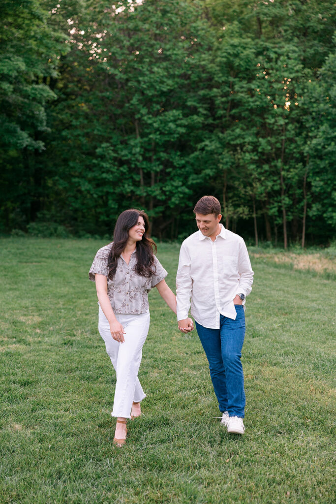 Jenna and Aaron walking together during their Cherokee Park engagement session in Louisville KY