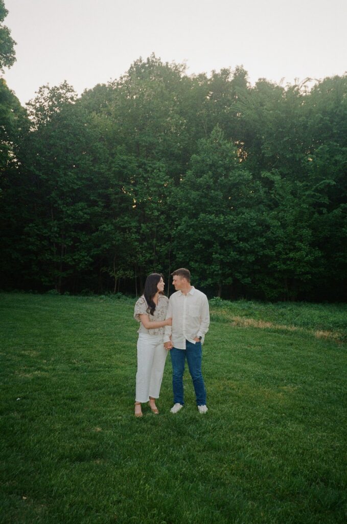 Jenna and Aaron embracing during their outdoor engagement session in Louisville KY